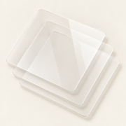 Three transparent Retro Kid tempered glass screen protectors on a cream studio background.